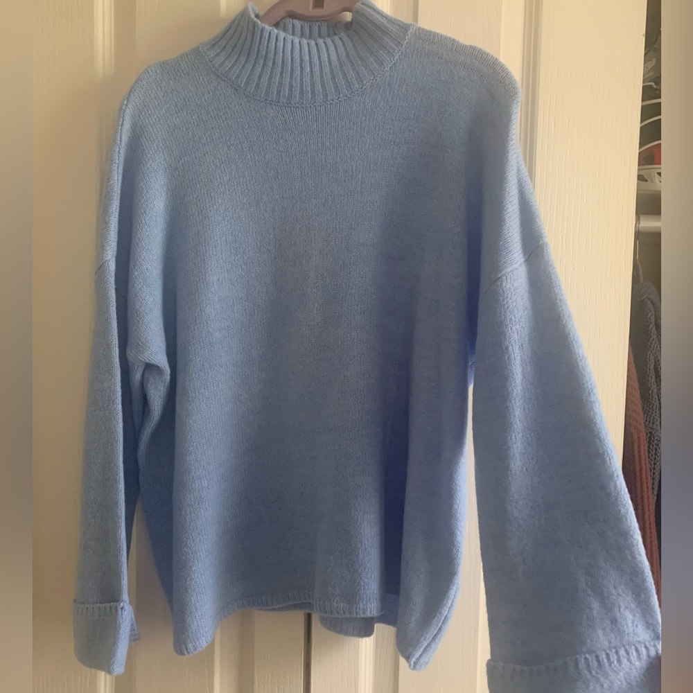 Blue turtleneck with bell sleeves. Size XS. NEVER WORN